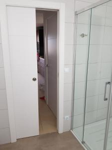 a bathroom with a shower and a glass door at Exclusive Apartment - Playa de Marenys de Rafalcaid in Gandía