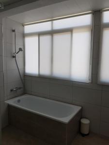 a bath tub in a bathroom with a window at Exclusive Apartment - Playa de Marenys de Rafalcaid in Gandía