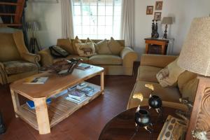 a living room with a couch and a coffee table at Treetops Marloth Park in Marloth Park