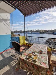 a table with a plate of food on a boat at El-amin Guest House in Aswan