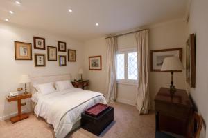 a bedroom with a white bed and a window at Villa Piera Maspalomas in Maspalomas +34 photos