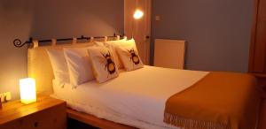 a bedroom with a large white bed with two pillows at Ardlui in Anstruther