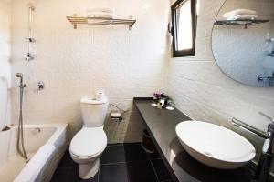 a bathroom with a toilet and a sink and a tub at Jerusalem Inn by Smart Hotels in Jerusalem