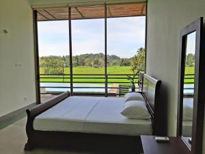 a bedroom with a bed in front of a large window at Sugoi House in Unawatuna +87 photos