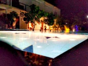 a large pool of water in a building at night at Wavelength in Mirissa