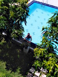 a man is sitting in a swimming pool at Wavelength in Mirissa