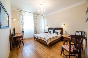 a bedroom with a bed and a table and a desk at Guesthouse Bistra in Vrhnika