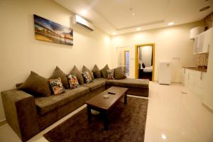 a living room with a couch and a table at Quiet Rooms 1 Serviced Apartments in Riyadh