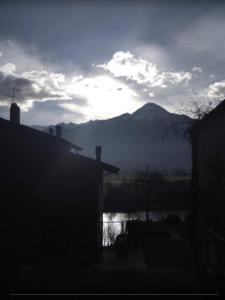 a view of a mountain with the sun in the sky at Holiday home Désirée in Sorico +9 photos