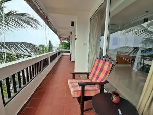 a balcony with a chair and a table at La Veranda Di Serena in Unawatuna