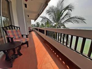 a balcony with a bench and a view of the ocean at La Veranda Di Serena in Unawatuna