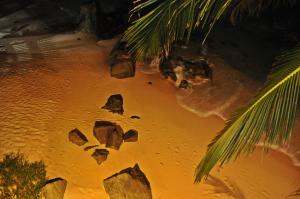 a bunch of rocks in the water at night at La Veranda Di Serena in Unawatuna