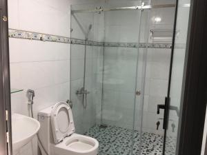 a bathroom with a shower and a toilet and a sink at Con Son Green Island in Con Dao