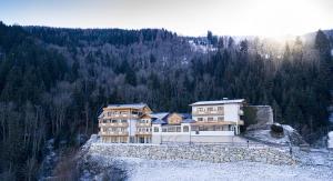 a large house on top of a stone wall at Rohrmooser Schlössl in Schladming