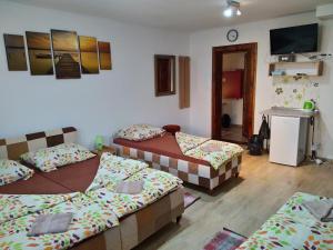 A bed or beds in a room at András penzión