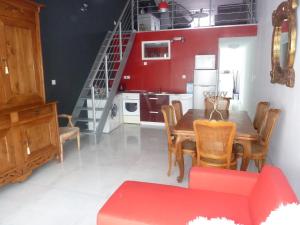 a kitchen and dining room with a table and chairs at Gite Au Cheval D'or in La Meilleraie-Tillay