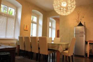 a dining room with a table and chairs and a chandelier at Pappel in Berlin