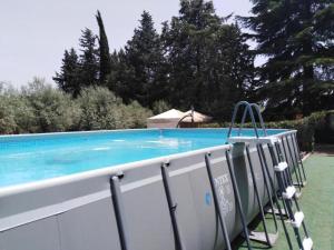 a swimming pool with a blue water at B&B Villa Casablanca in Enna