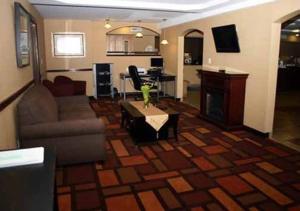 a living room with a couch and a table at Quality Inn in Dunkirk