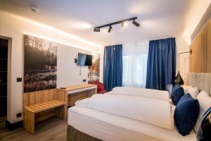 Postel nebo postele na pokoji v ubytování Hotel Wilder Mann