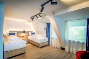 Postel nebo postele na pokoji v ubytování Hotel Wilder Mann