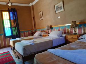 A bed or beds in a room at Villa Nile House Luxor