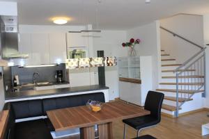 a kitchen with a table and a sink and a staircase at Ferienapartment Nassfeld in Sonnenalpe Nassfeld