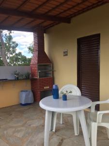 a white table and chairs on a patio at Pousada Recanto das Pedras São Leopoldo in Pirenópolis