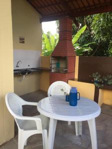 a white table and two chairs on a patio at Pousada Recanto das Pedras São Leopoldo in Pirenópolis