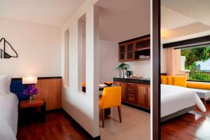a hotel room with a bed and a desk at Avani Ao Nang Cliff Krabi Resort in Ao Nang Beach