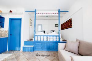 a living room with a blue cabinet and a couch at Glaros luxury studio on the Beach in Arkasa