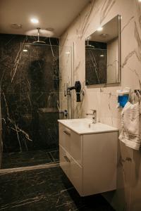 La salle de bains est pourvue d'un lavabo et d'une douche. dans l'établissement Hayat Palas, à Erzincan