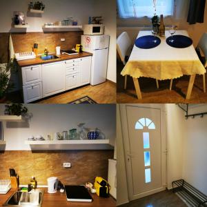 a kitchen with white cabinets and a table and a sink at DalmApartman in Budapest