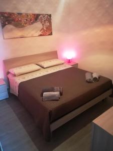 a bedroom with a bed with a light on it at Elegance apartment Taormina in Letojanni