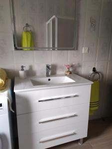 a bathroom with a white sink and a mirror at Casa Rural El Cabo in Carucedo +23 photos