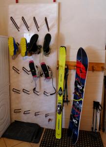 a bunch of snowboards are hanging on a wall at Willa Modrysówka in Zawoja