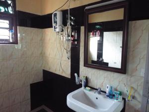 a bathroom with a sink and a mirror at Ceylon Epic Inn in Bentota +7 photos