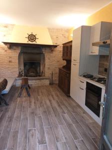 a kitchen with a stove and a fireplace at La Corte di Nonno Gino in Stresa