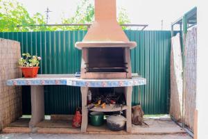 a outdoor pizza oven sitting on a patio at Hotel Kings Zatoka in Zatoka