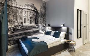 a bedroom with a black and white picture of a building at Catalog Boutique Rooms in Debrecen