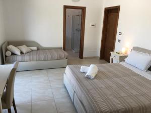 Postel nebo postele na pokoji v ubytování Villa Elia - Tenuta Le Scerze - Salento Homes