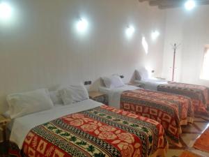 En eller flere senger på et rom på Riad Amodou