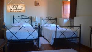 a bedroom with two beds and a sign on the wall at Quinta da Várzea de Cima in Marco de Canaveses