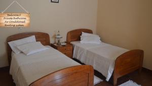 two beds sitting next to each other in a bedroom at Quinta da Várzea de Cima in Marco de Canaveses