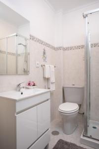 een witte badkamer met een toilet en een douche bij Home Sweet Home in Ílhavo