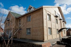 a brick building with a tower on top of it at ApartHotel na Berezovoy in Zelenaya Polyana