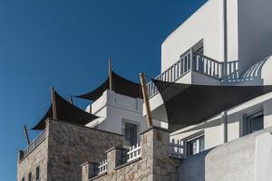 a white building with balconies on top of it at Saluti Da Stampalia in Astypalaia Town