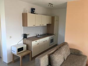 a living room with a couch and a microwave at Haus Am Wald in Wasungen +4 photos
