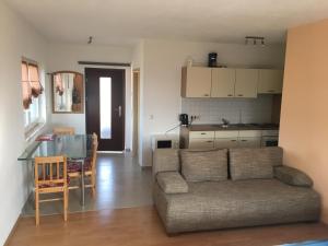 a living room with a couch and a table and a kitchen at Haus Am Wald in Wasungen