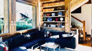 a living room with a blue couch and a table at Chalet Alexandra in Les Houches